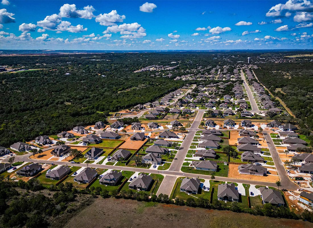 New Braunfels, TX - Aerial View of a Newly Built Homes Surrounded by Green Trees in New Braunfels Texas